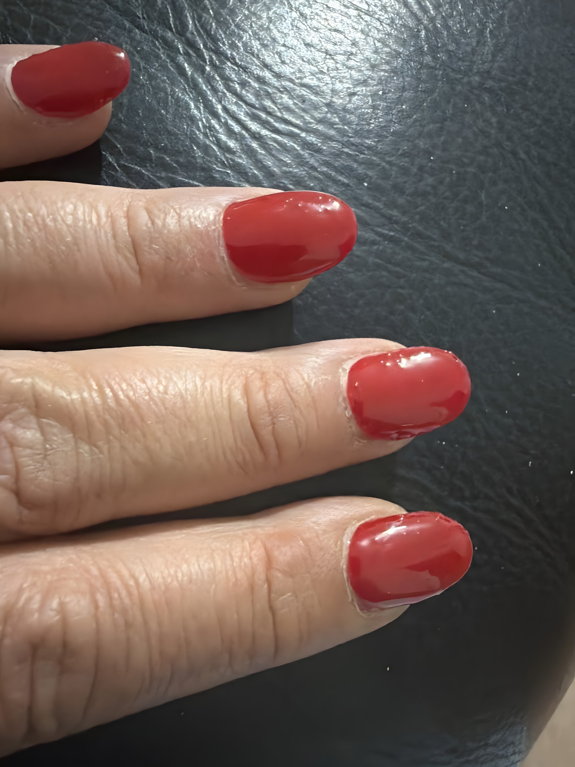 Glossy red round gel manicure